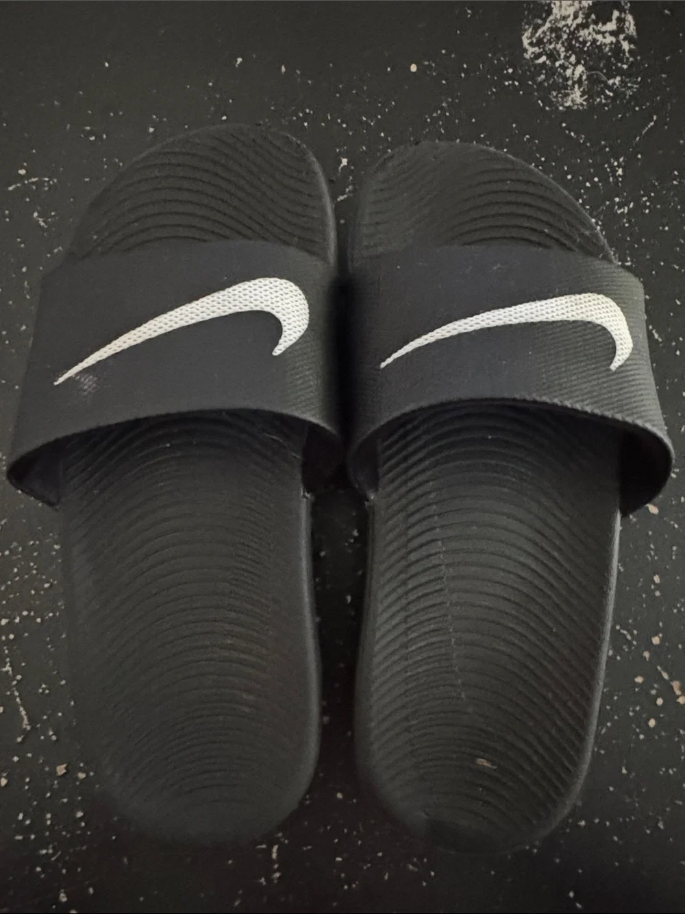 Nike Black Slides with White Swoosh Logos
